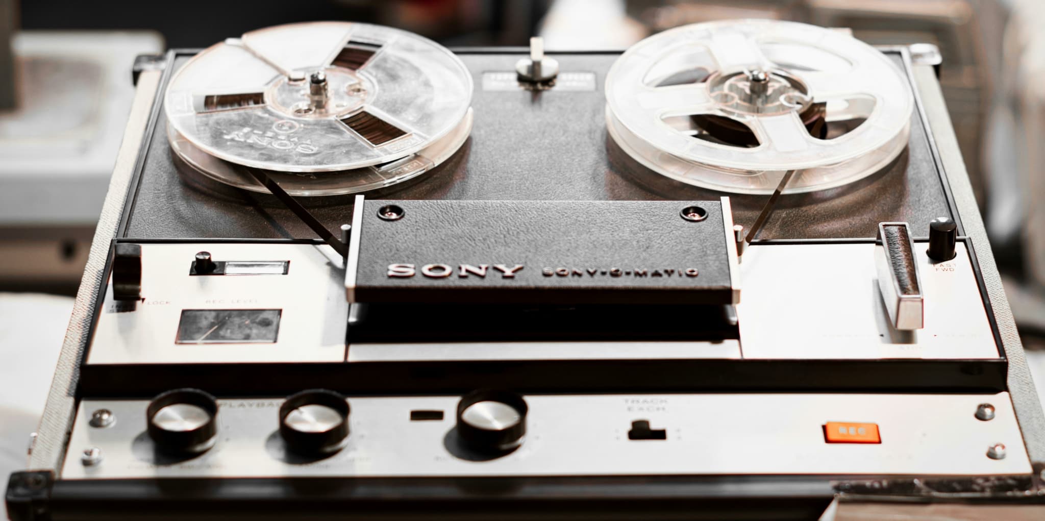 Sony reel-to-reel tape recorder with visible playback and recording controls.