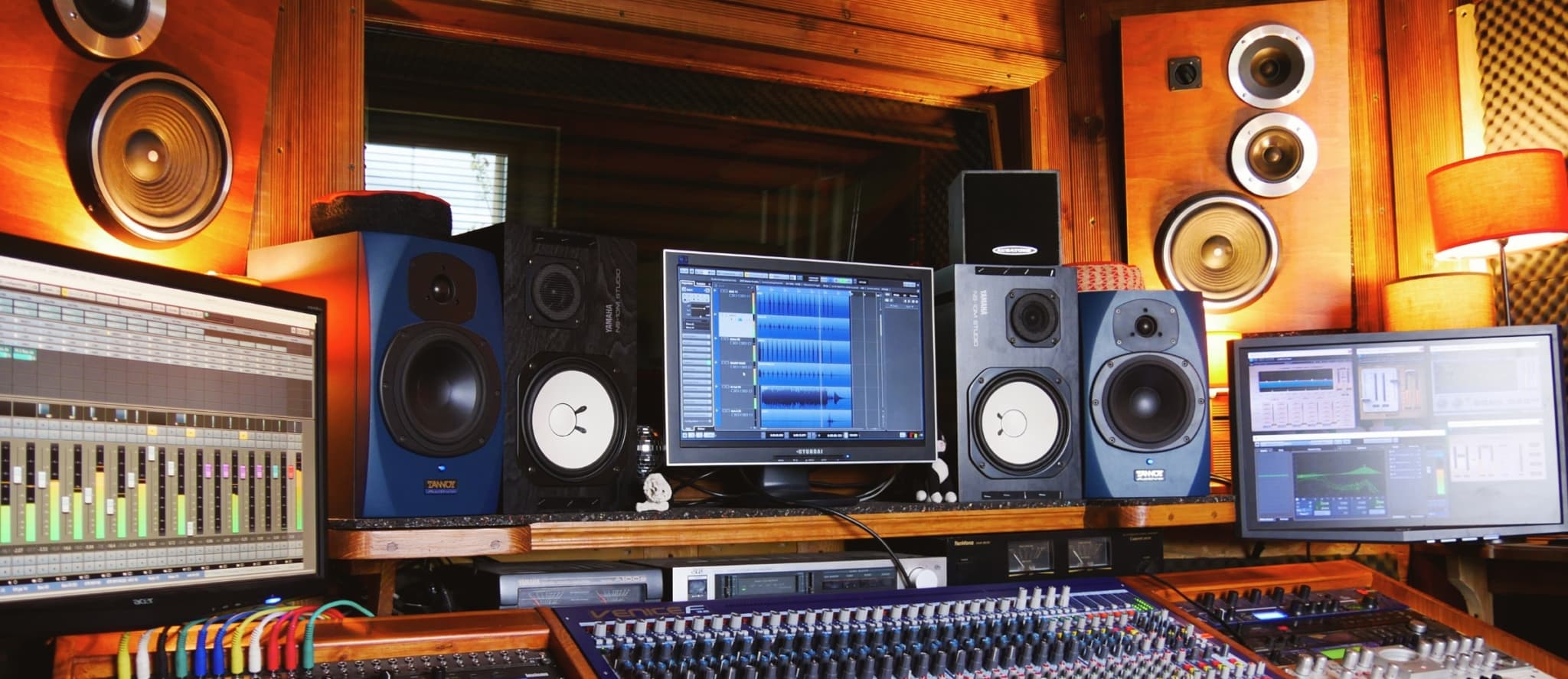 Dolby Atmos Audio production studio with mixing console and monitors