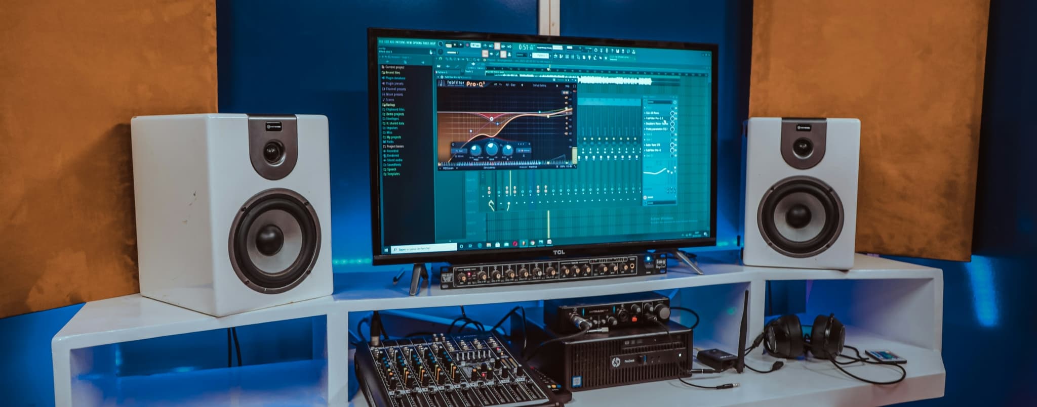 Audio production setup featuring monitors, mixer, and software interface.