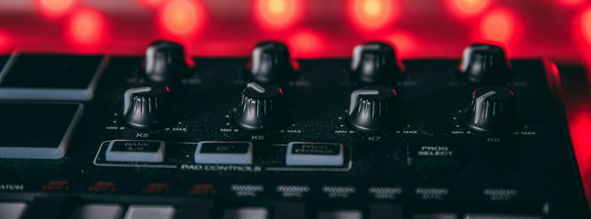 Close-up of a MIDI controller with various knobs and buttons